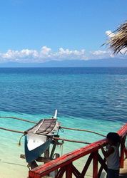 fishing boat and kid at panagsma beach in moalboal